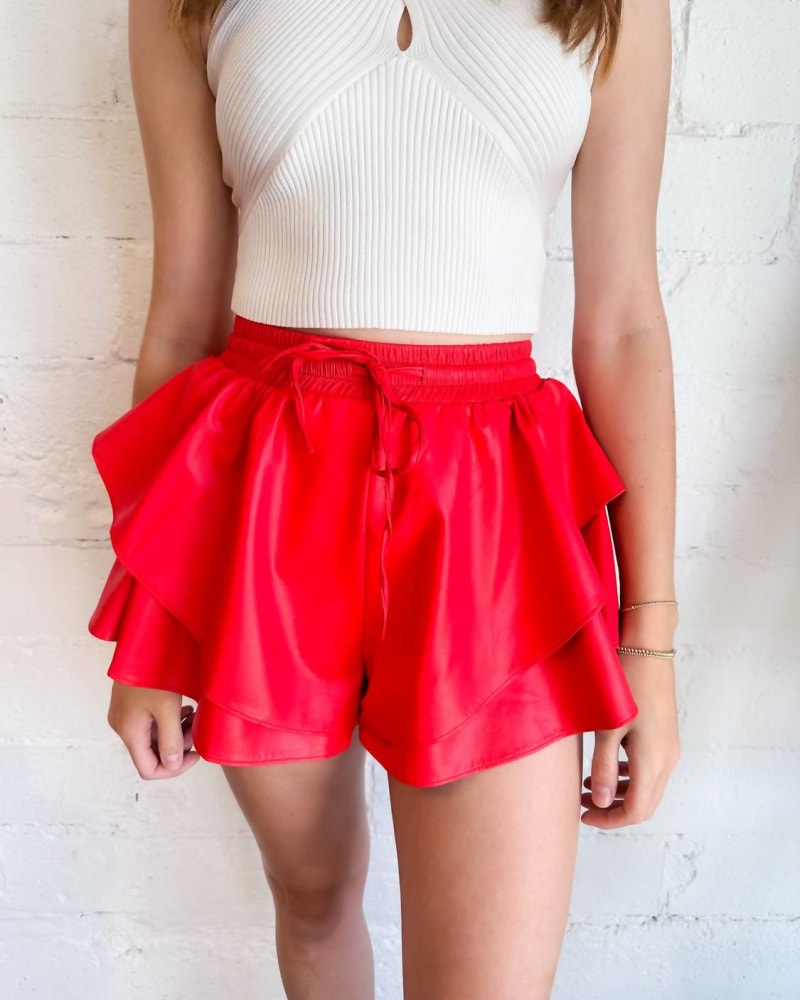 Front of a model wearing a size Large Kick It Faux Leather Skort In Red in Red by Idem Ditto. | dia_product_style_image_id:360342